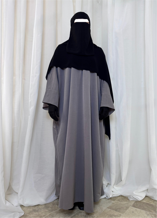 Elegant loose-fitting abaya designed for summer, made from airy textured fabric with a batwing silhouette