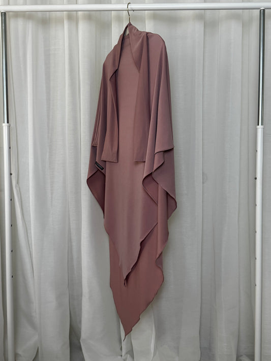 Soft pink jersey khimar made from breathable fabric with loose drape for modest coverage. Perfect for prayer, daily wear, and comfort.